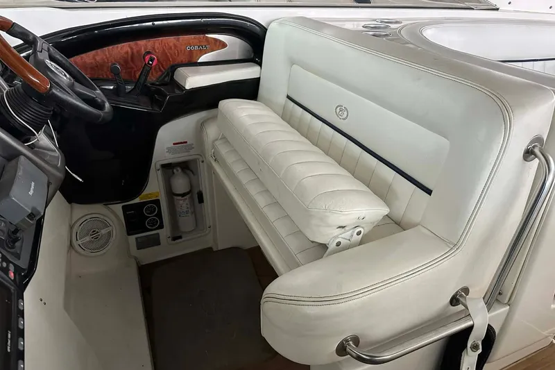 Slide: The Image of 2004 Cobalt 360 Cruiser interior with white seating and control panel. - 17