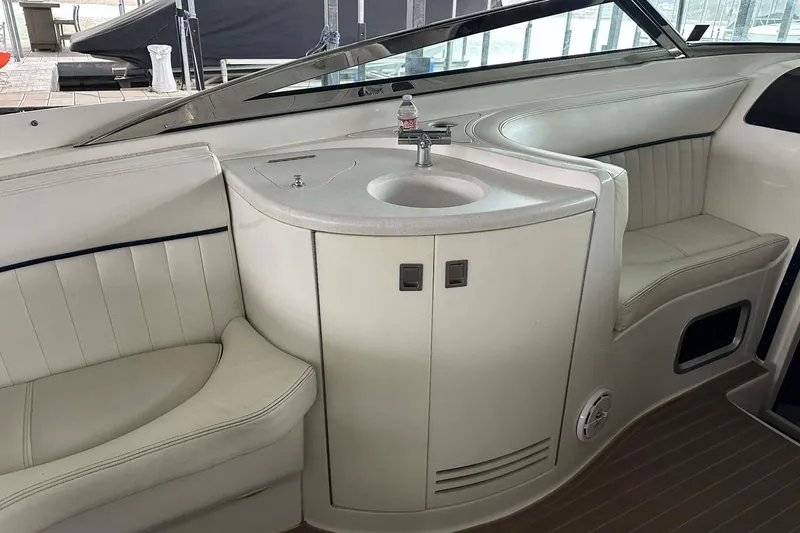 Slide: The Image of Interior of a 2004 Cobalt 360 Cruiser with seating and a compact sink area. - 22