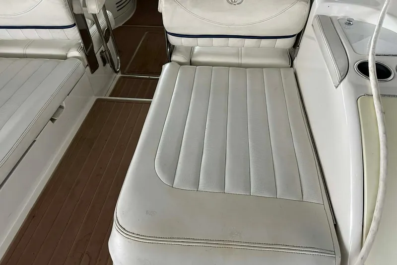 Slide: The Image of 2004 Cobalt 360 Cruiser interior with white leather seating and wooden flooring. - 23