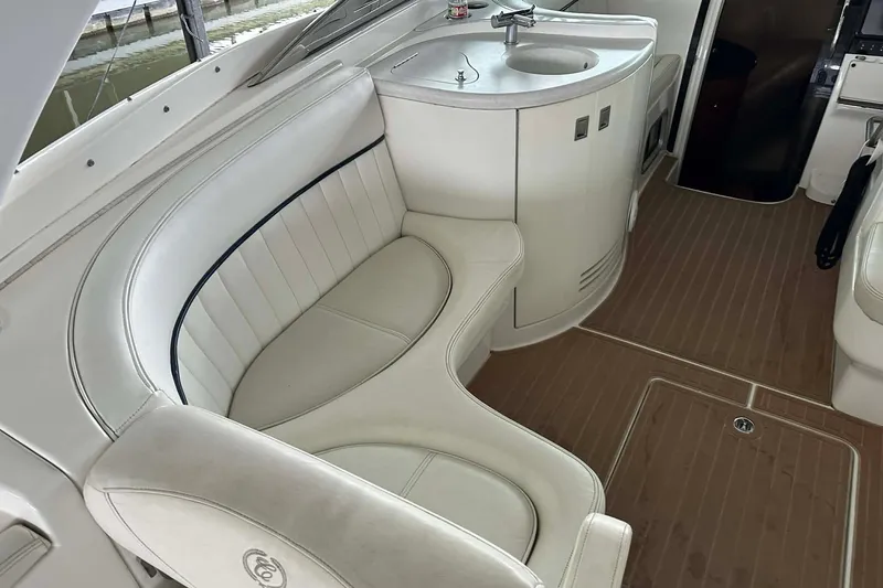 Slide: The Image of 2004 Cobalt 360 Cruiser interior with white seating and compact sink area. - 24