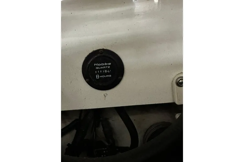 Slide: The Image of Hobbs Quartz hour meter on 2004 Cobalt 360 Cruiser dashboard. - 25