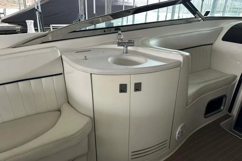 Slide: The Image of 2004 Cobalt 360 Cruiser interior with sink and seating area. - 8