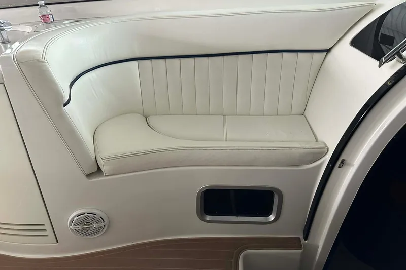 Slide: The Image of 2004 Cobalt 360 Cruiser interior with white leather seating and wood flooring. - 9