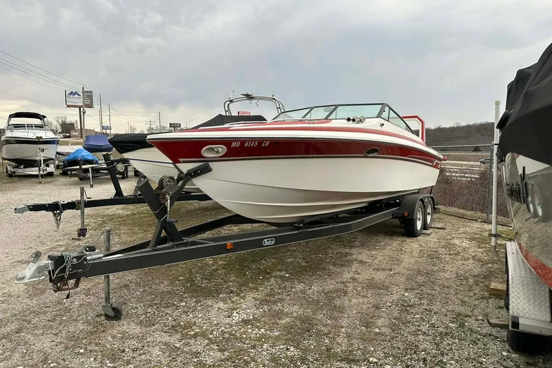 The Image of 1987 IMP 255 Eleganza boat on trailer in outdoor storage lot. - 1