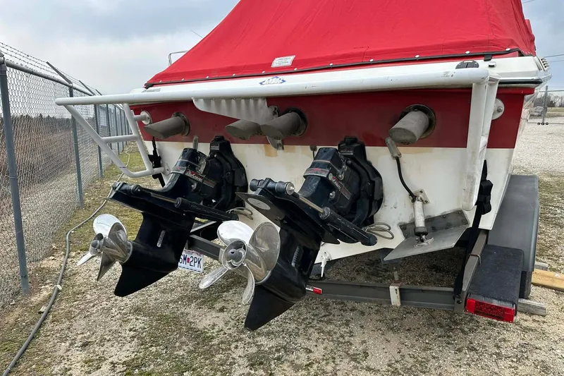 Slide: The Image of 1987 IMP 255 Eleganza boat with dual outboard motors and red cover. - 13