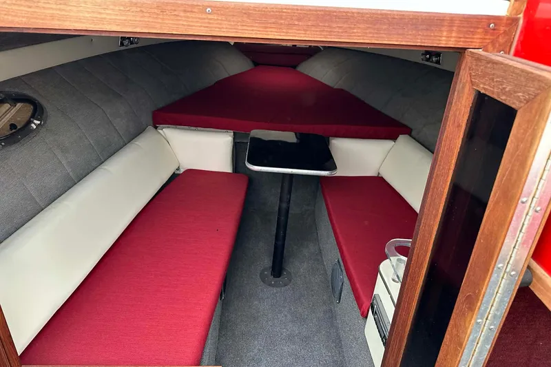 Slide: The Image of Interior of 1987 IMP 255 Eleganza boat with red and white seating. - 14