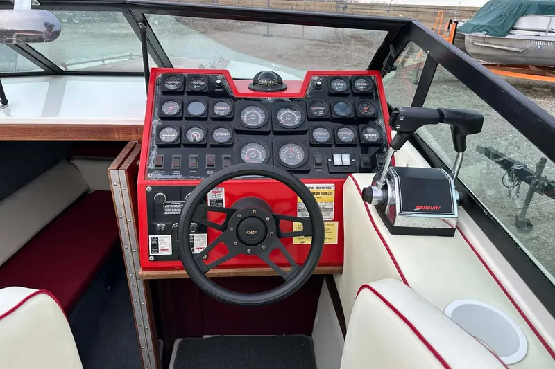 Slide: The Image of 1987 IMP 255 Eleganza boat dashboard with steering wheel and Mercury throttle controls. - 4