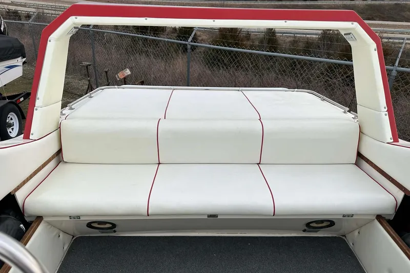 Slide: The Image of 1987 IMP 255 Eleganza boat interior with white and red cushioned seating. - 8