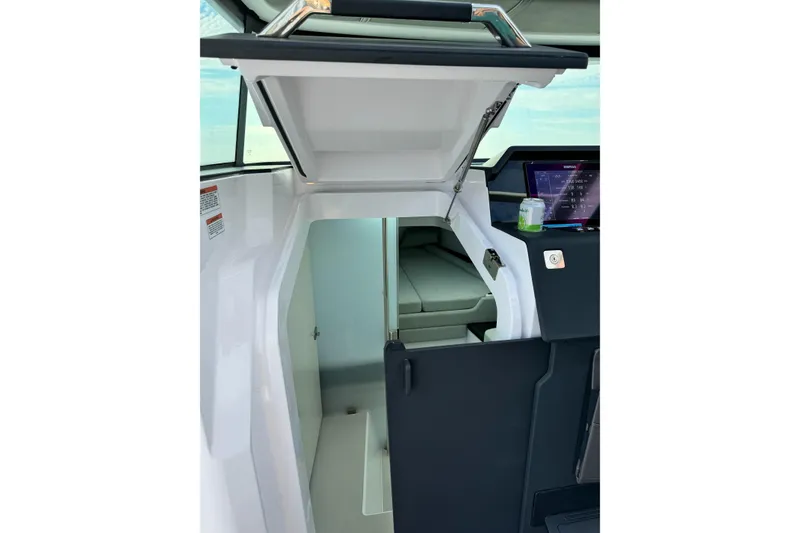 Slide: The Image of 2023 Axopar 37 XC Cross Cabin dashboard with navigation screens and steering wheel. - 10