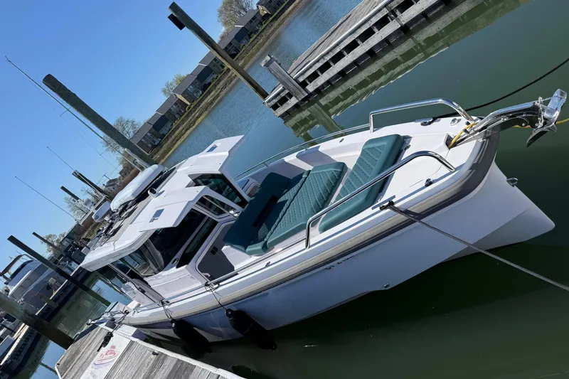 Slide: The Image of 2023 Axopar 37 XC Cross Cabin boat docked at a marina. - 16