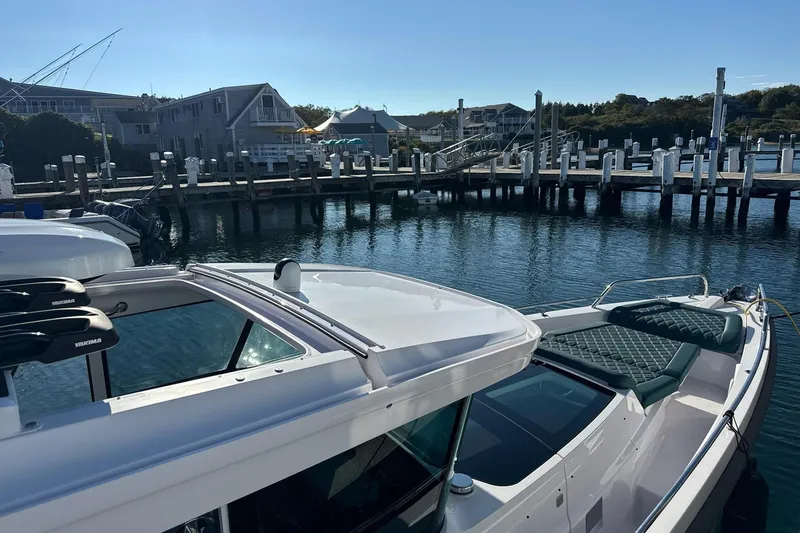 Slide: The Image of 2023 Axopar 37 XC Cross Cabin roof detail against clear blue sky. - 6