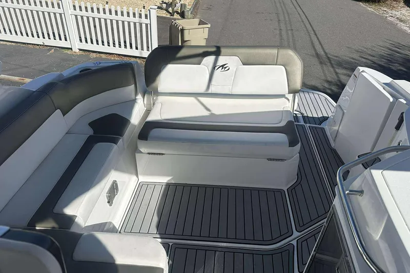 Slide: The Image of 2019 Monterey 295 Sport Yacht interior with sleek seating and modern design. - 11