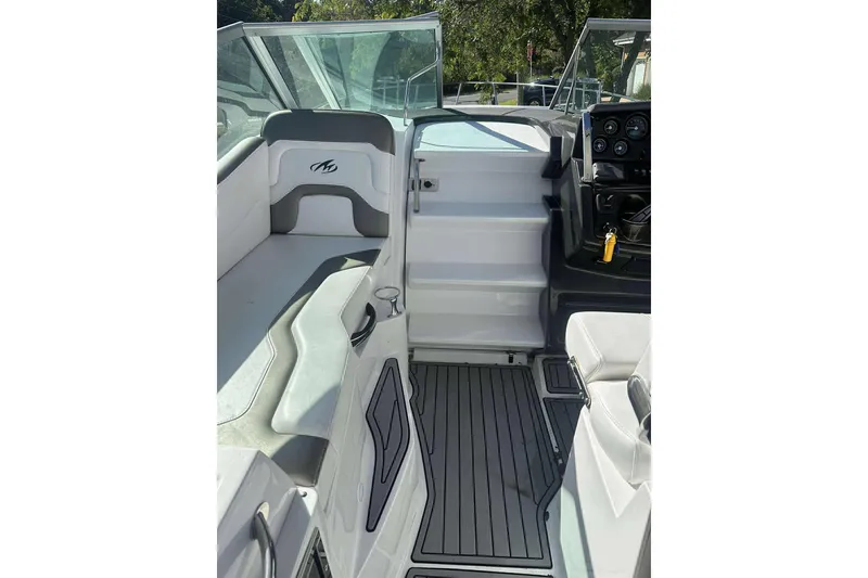 Slide: The Image of 2019 Monterey 295 Sport Yacht interior with seating and dashboard view. - 14