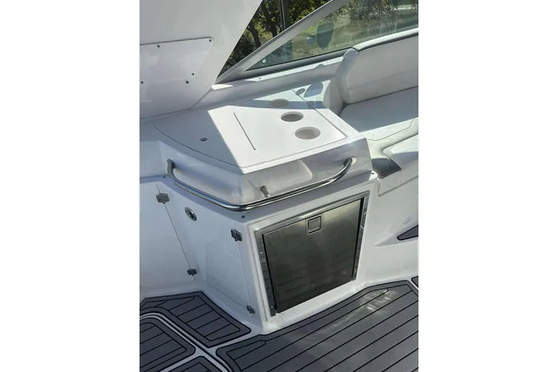 Slide: The Image of 2019 Monterey 295 Sport Yacht interior with seating and built-in cooler. - 15