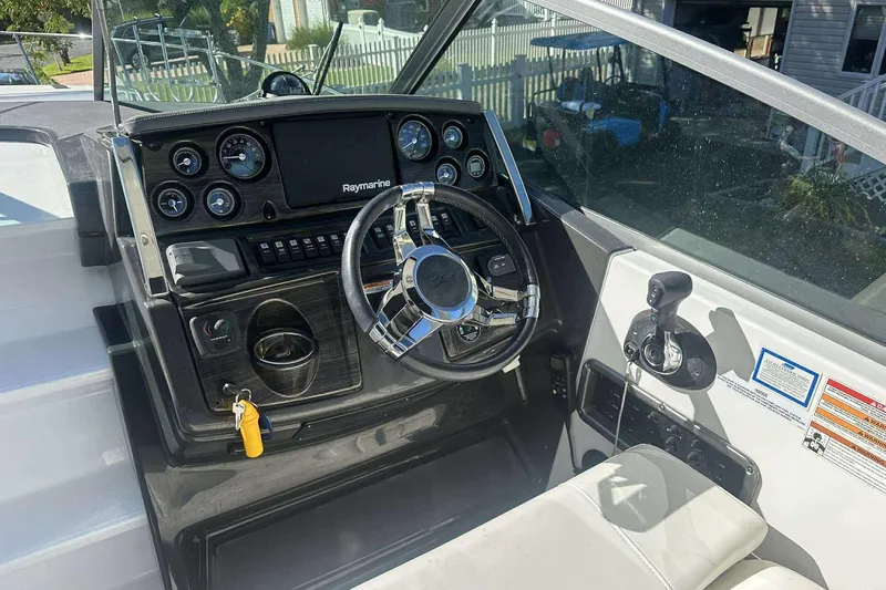 Slide: The Image of 2019 Monterey 295 Sport Yacht helm with Raymarine display and modern controls. - 17