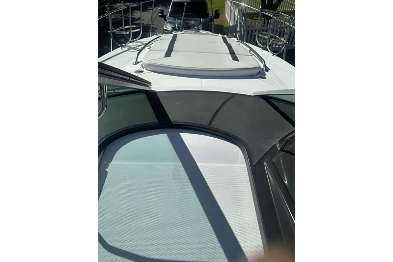 Slide: The Image of 2019 Monterey 295 Sport Yacht deck with sunpad and railing. - 18