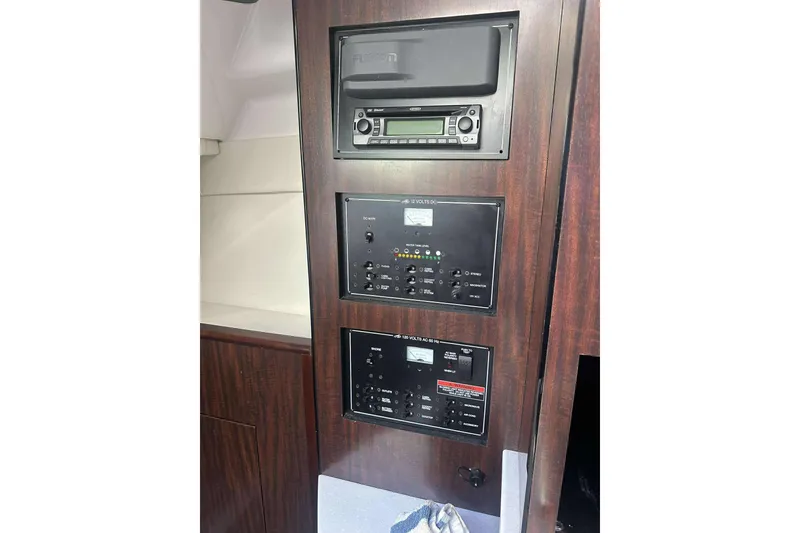 Slide: The Image of 2019 Monterey 295 Sport Yacht control panel with stereo and electrical switches. - 22