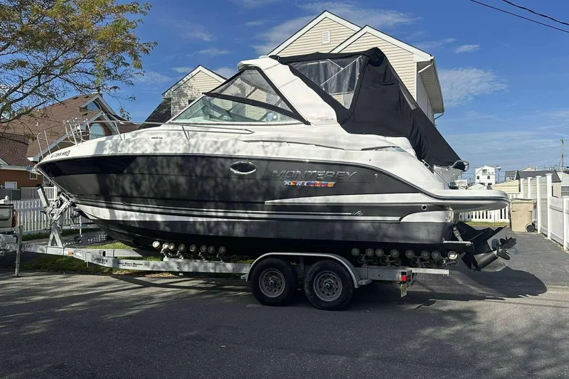 Slide: The Image of 2019 Monterey 295 Sport Yacht on trailer, parked in residential driveway. - 4