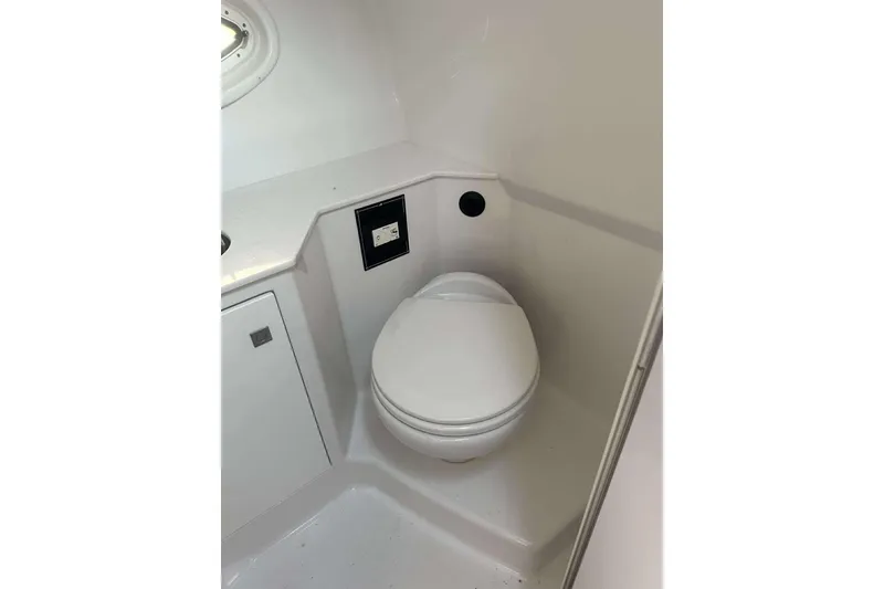 Slide: The Image of 2019 Monterey 295 Sport Yacht bathroom with compact toilet and modern design. - 6