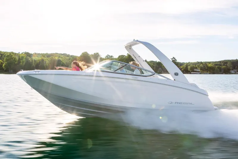 The Image of Manufacturer Provided Image: 2020 Regal 22 FasDeck speedboat cruising on a lake with passengers. - 0