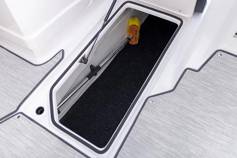 Slide: The Image of Manufacturer Provided Image: 2020 Regal 22 FasDeck storage compartment with cleaning brush. - 12