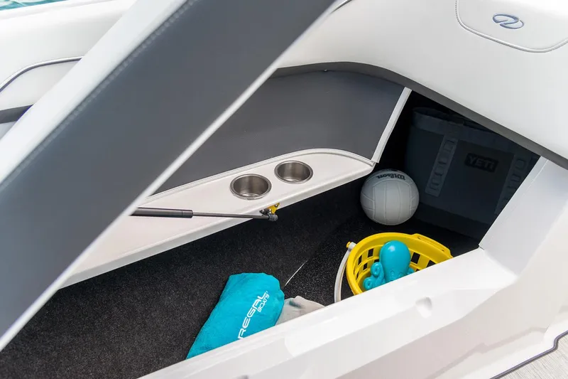 Slide: The Image of Manufacturer Provided Image: Storage compartment in a 2020 Regal 22 FasDeck boat with cup holders and accessories. - 13