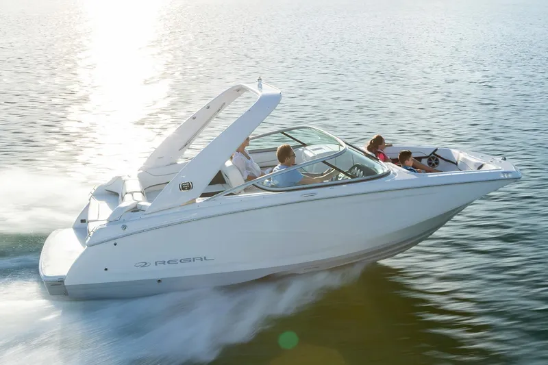 Slide: The Image of Manufacturer Provided Image: 2020 Regal 22 FasDeck boat cruising on water with passengers. - 2