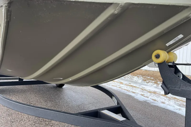 Slide: The Image of Underside of a Tracker Grizzly 1860 CC boat on a trailer. - 12