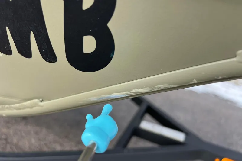 Slide: The Image of Close-up of a 2021 Tracker Grizzly 1860 CC boat with scratches. - 15