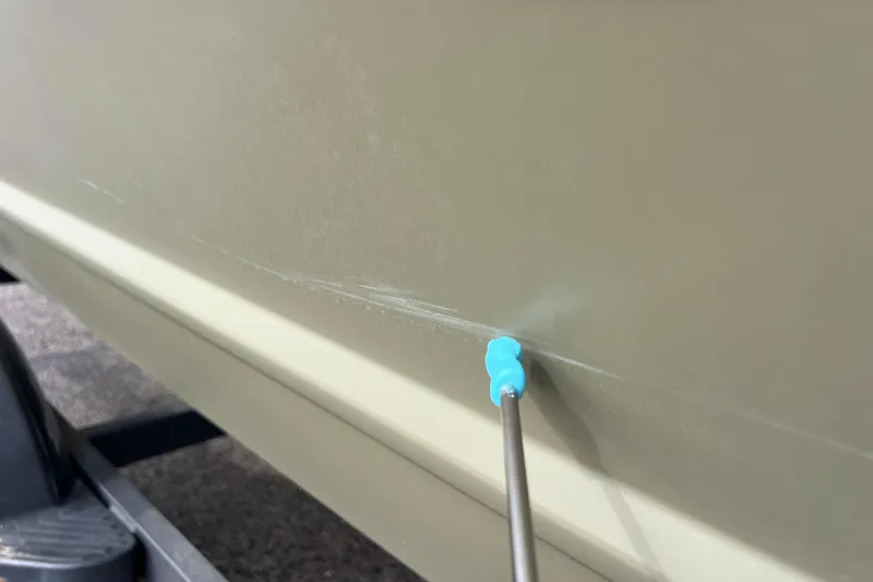 Slide: The Image of Close-up of a scratch on a Tracker Grizzly 1860 CC boat. - 17