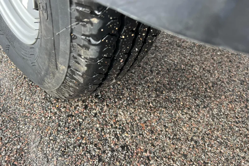 Slide: The Image of Close-up of a tire on wet pavement, Tracker Grizzly 1860 CC 2021. - 19