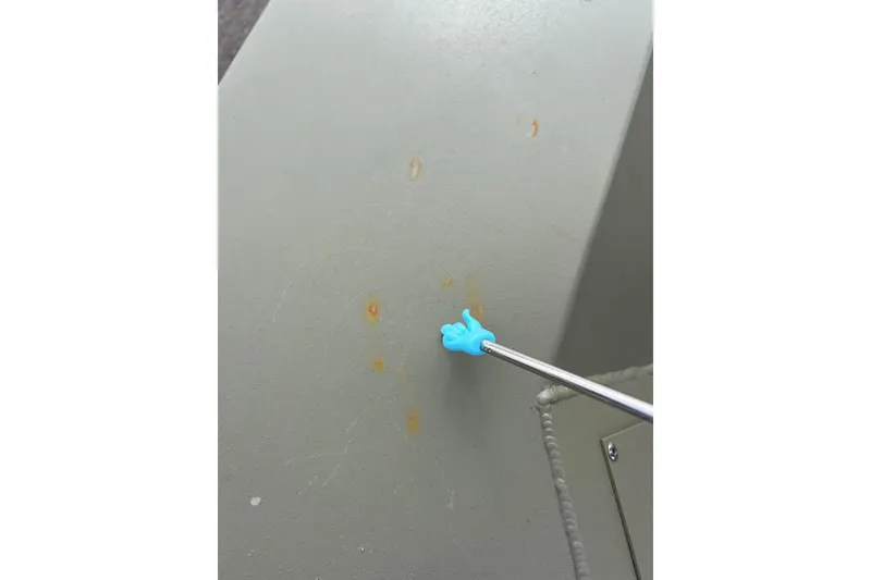 Slide: The Image of Blue hand pointing at rust spots on Tracker Grizzly 1860 CC, 2021. - 21