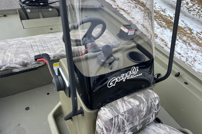 Slide: The Image of 2021 Tracker Grizzly 1860 CC with steering console and camouflage seats. - 26