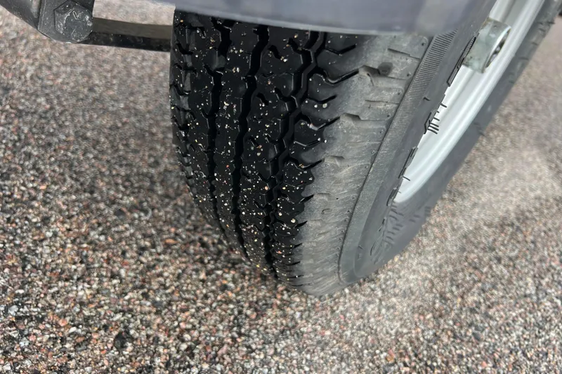 Slide: The Image of Close-up of a tire on gravel, Tracker Grizzly 1860 CC 2021. - 37