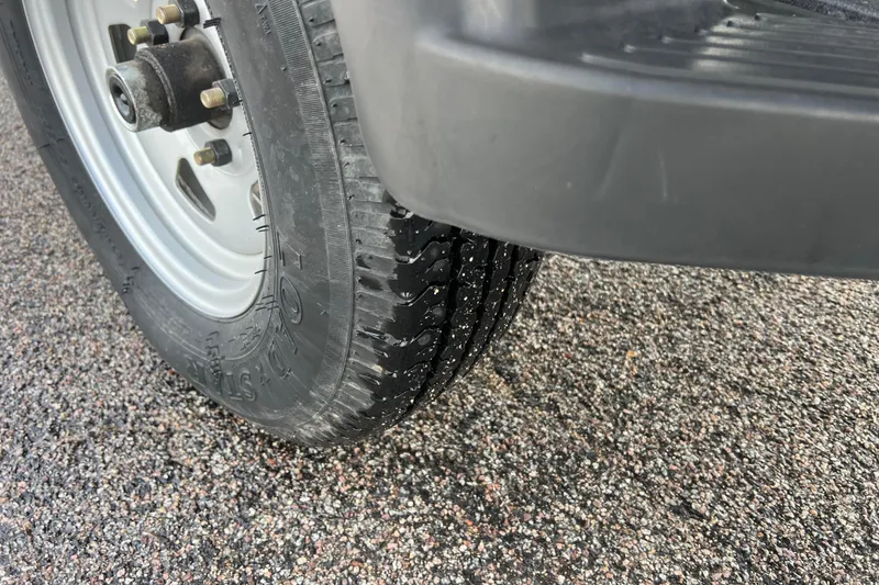 Slide: The Image of Close-up of a tire on wet asphalt, Tracker Grizzly 1860 CC 2021. - 40