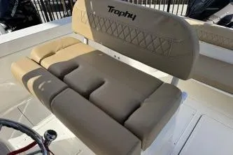Slide: The Image of 2023 Trophy T24 CC boat interior with beige cushioned seating. - 10