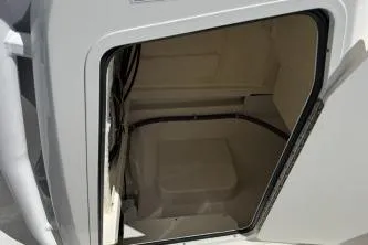Slide: The Image of 2023 Trophy T24 CC boat storage compartment with open hatch. - 9