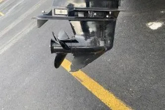 Slide: The Image of 1999 Sylvan 1700 boat motor propeller on asphalt surface. - 11