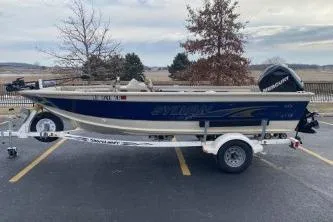 Slide: The Image of 1999 Sylvan 1700 boat on trailer in parking lot, overcast sky. - 4