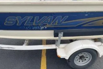 Slide: The Image of 1999 Sylvan 1700 boat on trailer, blue and beige color scheme. - 7