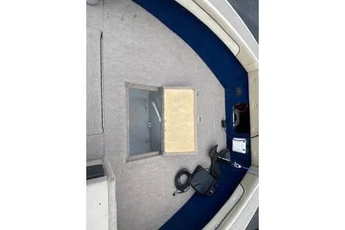 Slide: The Image of 1999 Sylvan 1700 boat interior with storage compartment and equipment. - 9