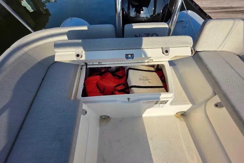 Slide: The Image of 2024 Zodiac N-ZO 680 boat storage compartment with life jackets and safety equipment. - 11