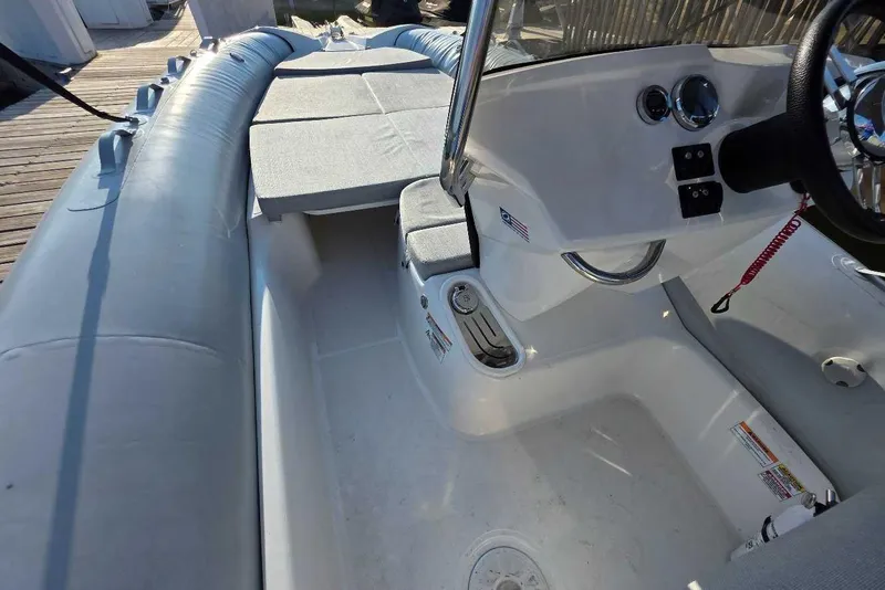 Slide: The Image of 2024 Zodiac N-ZO 680 boat interior with steering console and seating area. - 4