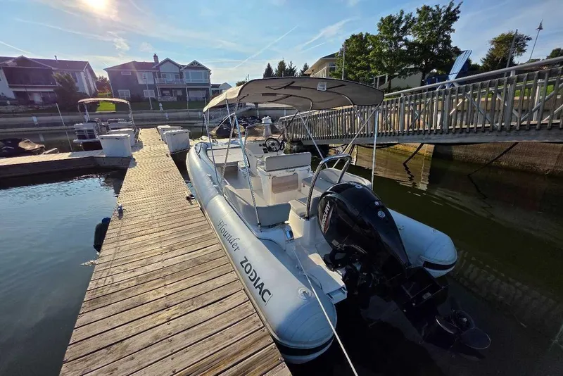 Slide: The Image of 2024 Zodiac N-ZO 680 boat docked at marina under sunny sky. - 5