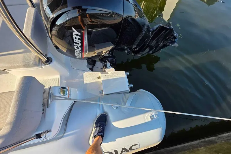 Slide: The Image of 2024 Zodiac N-ZO 680 boat with Mercury engine, docked on calm water. - 6