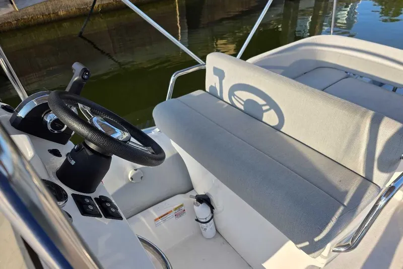 Slide: The Image of 2024 Zodiac N-ZO 680 boat interior with steering wheel and cushioned seating. - 8