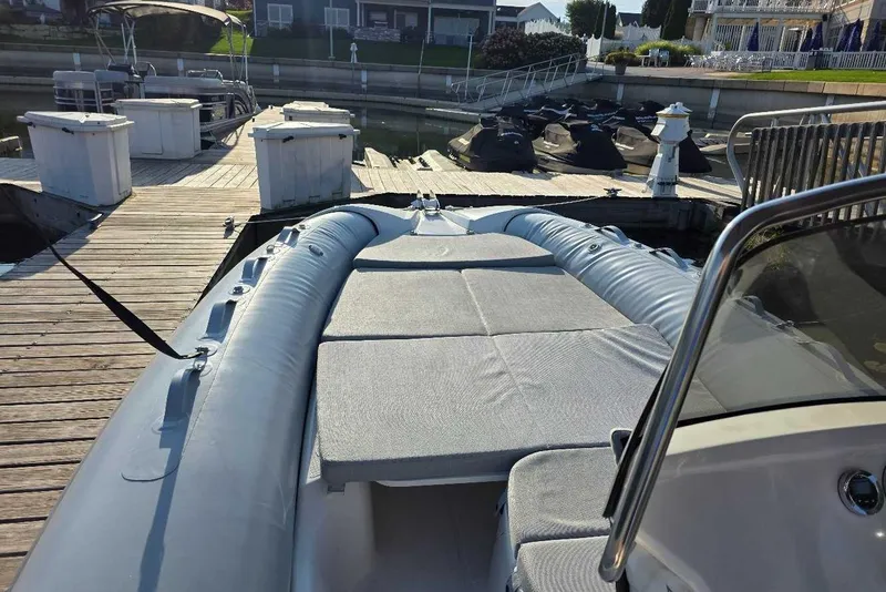 Slide: The Image of 2024 Zodiac N-ZO 680 boat docked, featuring spacious seating and sleek design. - 9