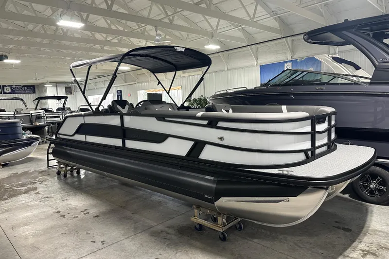 Slide: The Image of 2026 Evotti 525QL pontoon boat in showroom, featuring sleek design and modern canopy. - 22