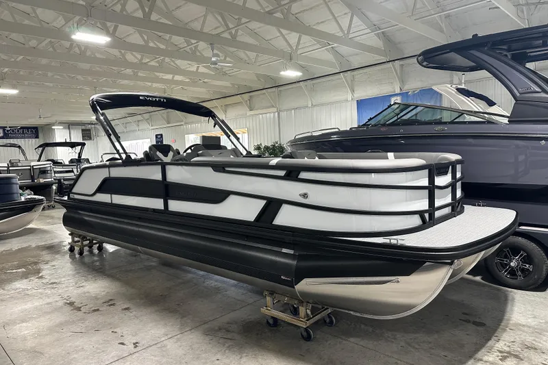 Slide: The Image of 2026 Evotti 525QL pontoon boat in a spacious indoor storage facility. - 4