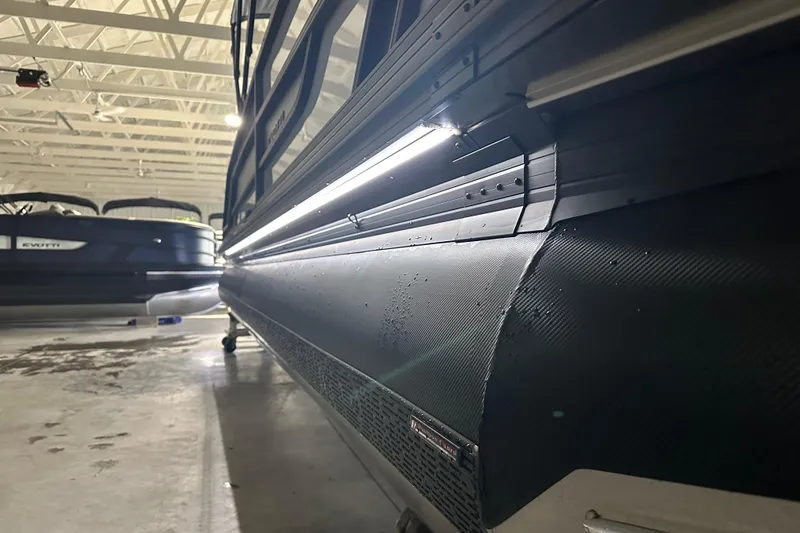 Slide: The Image of 2026 Evotti 525QL pontoon boat displayed in a showroom, featuring sleek design and modern amenities. - 6